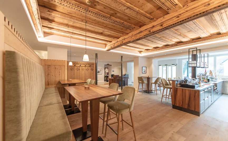 Bright restaurant with wooden ceilings and cozy seating areas