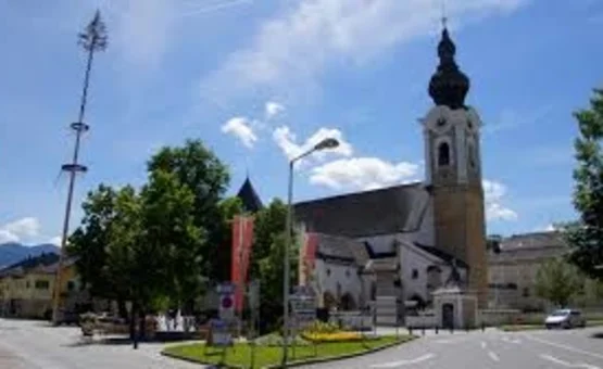 Großglockner tour Church and trees on a sunny street in a city