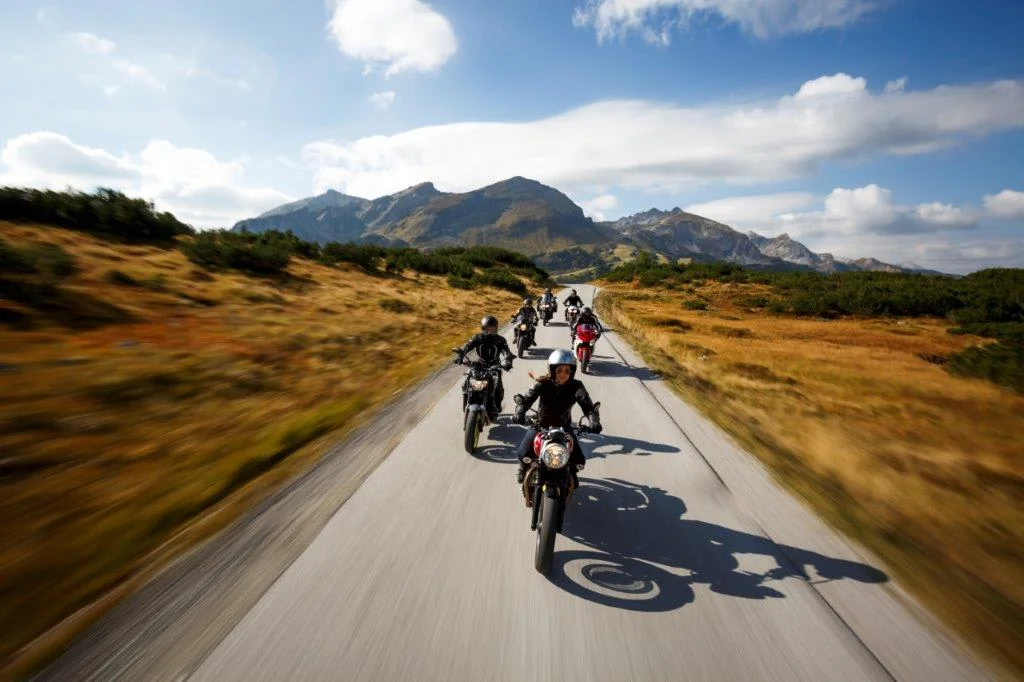 Group of motorcyclists riding on a mountain road