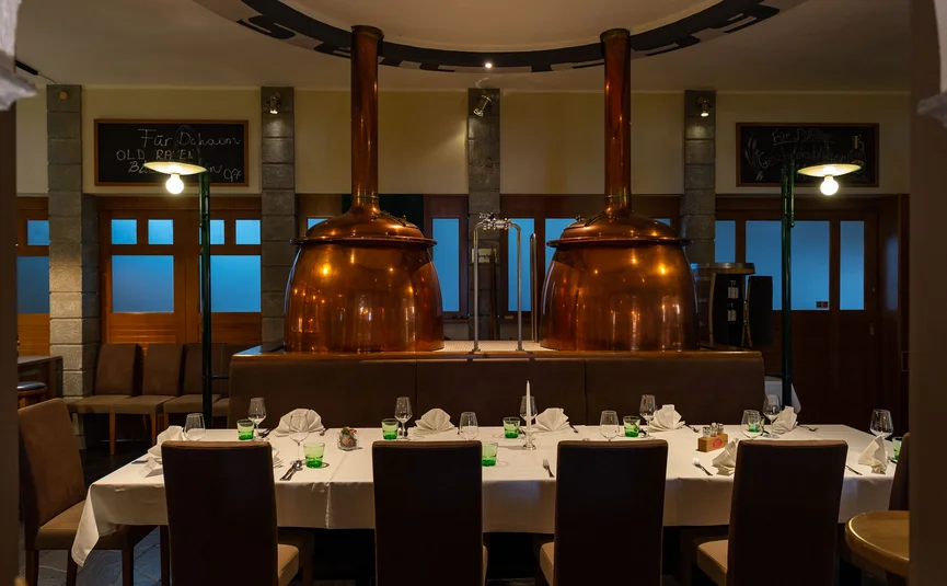 Set table with copper brewing kettles in restaurant