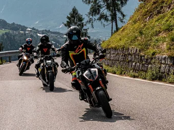 Valsugana - Kaiserjägerstrasse © Andrea Acler Three motorcycles riding on a mountain road with riders in protective gear