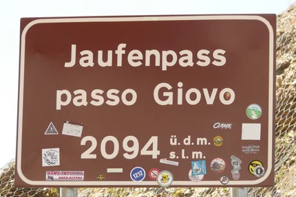 Road sign Jaufen Pass, altitude 2094 meters