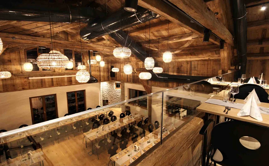 Landhotel & Gasthof Laudersbach *** Cozy restaurant with wooden beams, warm lights, and set tables