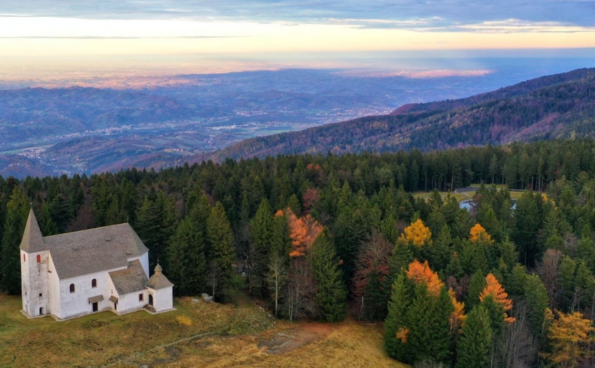 Styria Valleys & Areh Peak Tour Church in forest on mountain overlooking valley at sunset