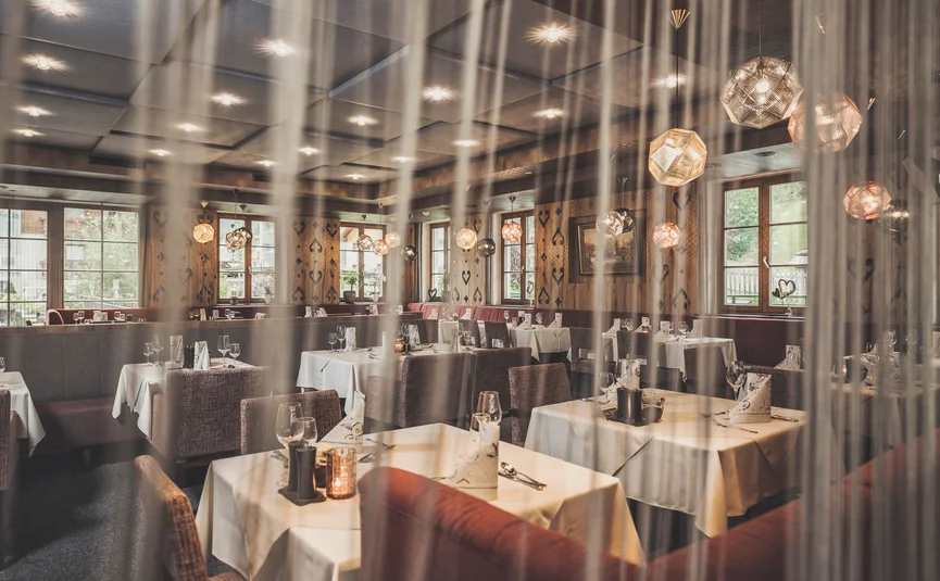 Elegant restaurant with set tables and modern pendant lights