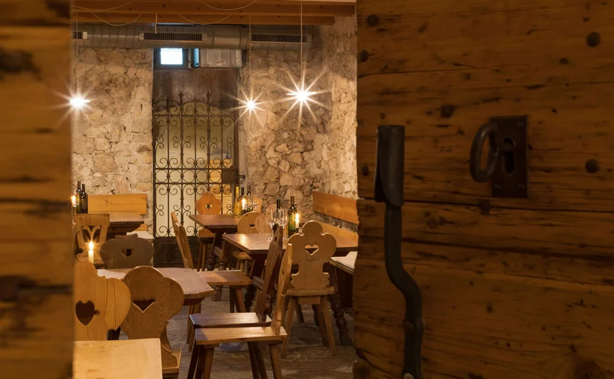 Cozy room with wooden furniture and rustic stone walls in a restaurant