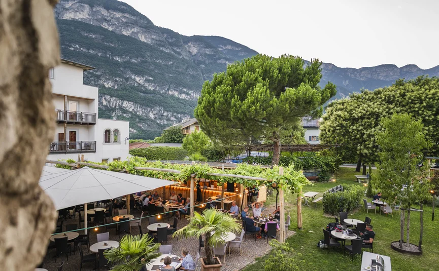 Outdoor restaurant terrace with guests and mountain view