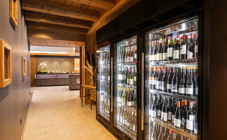 Wine coolers with bottles in modern restaurant corridor