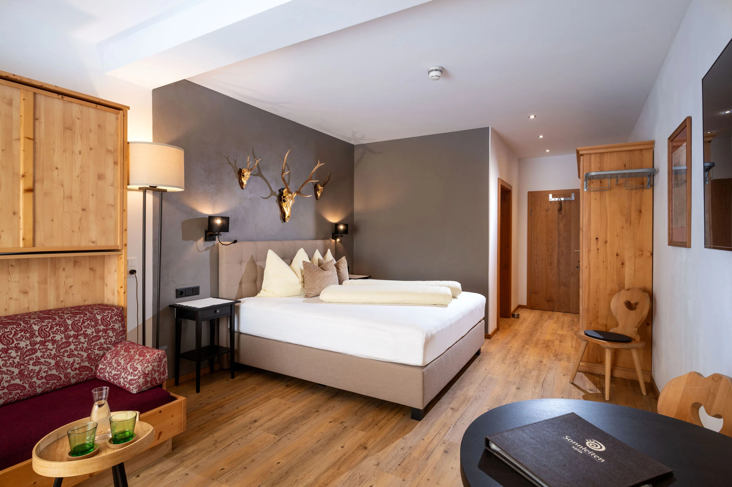 Cozy hotel room with double bed and rustic wooden decor