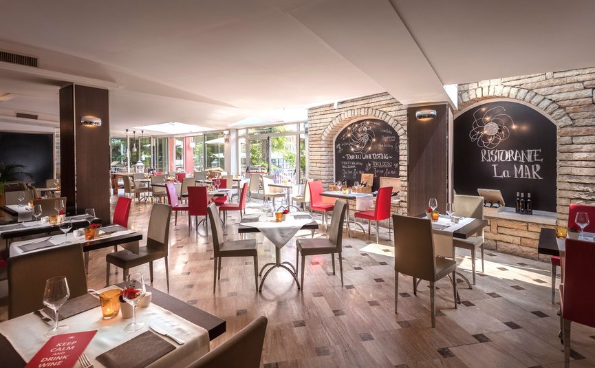 Bright modern restaurant with red and beige chairs and tables