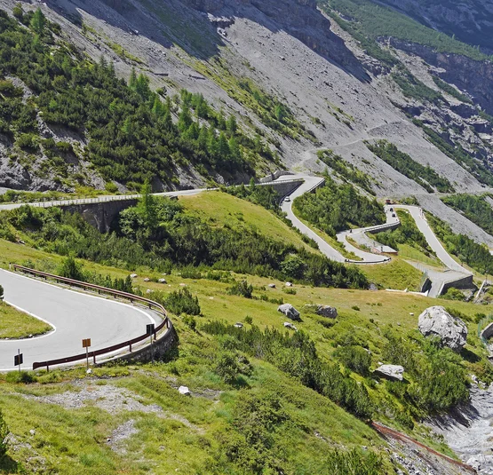 Stelvio Pass Winding mountain road with sharp curves near a river