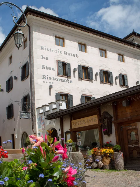 Historic hotel and restaurant La Stua with flowers in the foreground