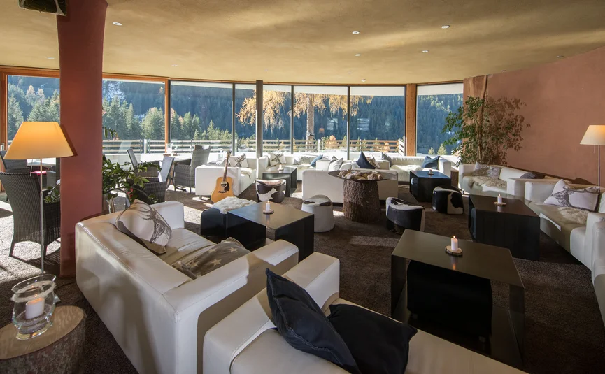 Cozy lounge with white sofas and mountain view