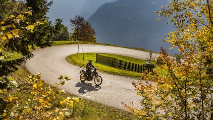 Südkärnten – Karawanken – Slowenien © Alexander Seger Motorradfahrer fährt durch eine kurvige Straße im herbstlichen Bergwald