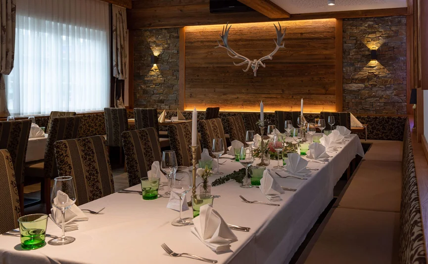 Elegant dining table in rustic restaurant with antlers and candles