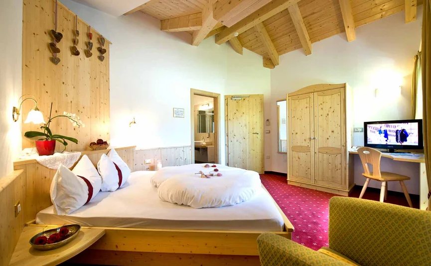 Cozy hotel room with wooden furniture and red carpet