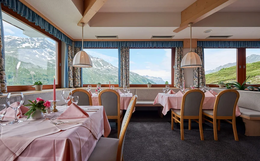 Restaurant with snow-capped mountain views and pink table settings