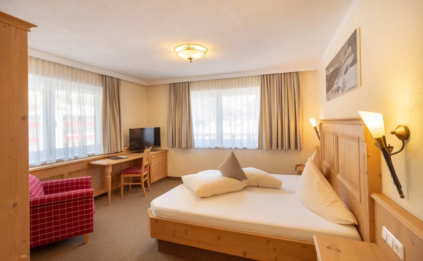 Cozy hotel room with wooden furniture and double bed