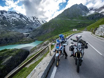 Großglockner - Hohe Tauern © Arturo Rivas Two motorcyclists on alpine road with mountain lake and snowy peaks