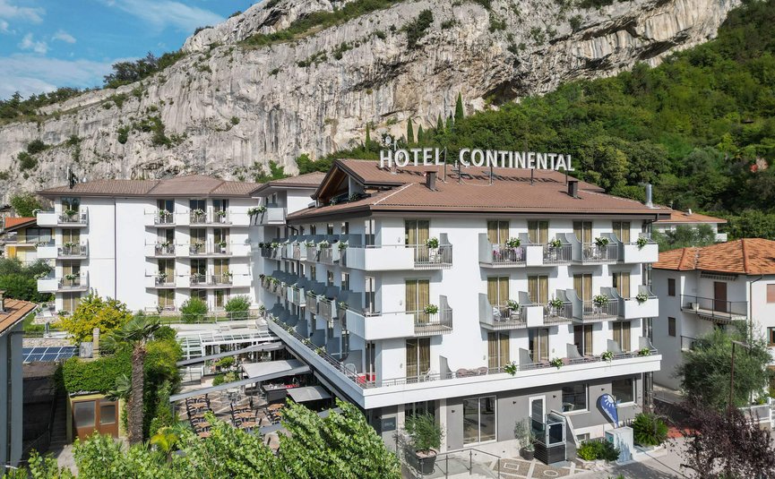 Hotel Continental with balconies and outdoor seating by rocky mountain
