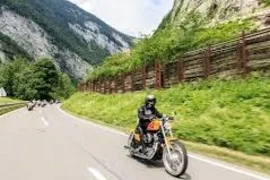 Großglockner tour Motorcyclist riding on a mountain road with others in the background