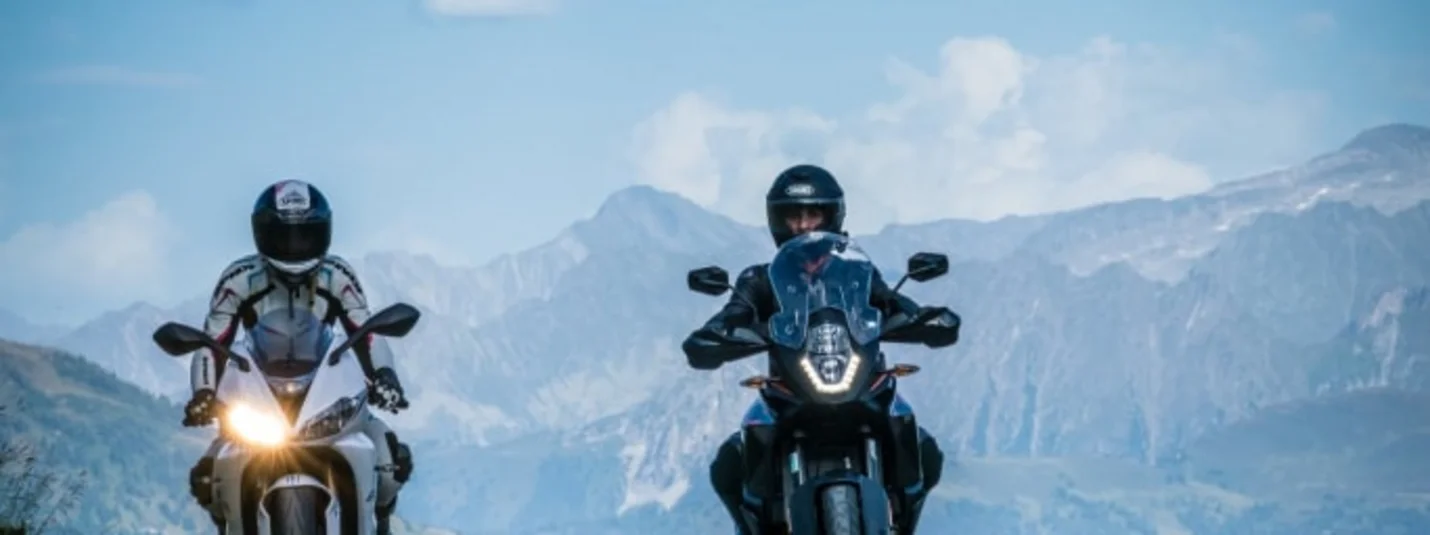 5 Tages Motorrad Angebot Twee motorrijders op bergweg onder bewolkte lucht