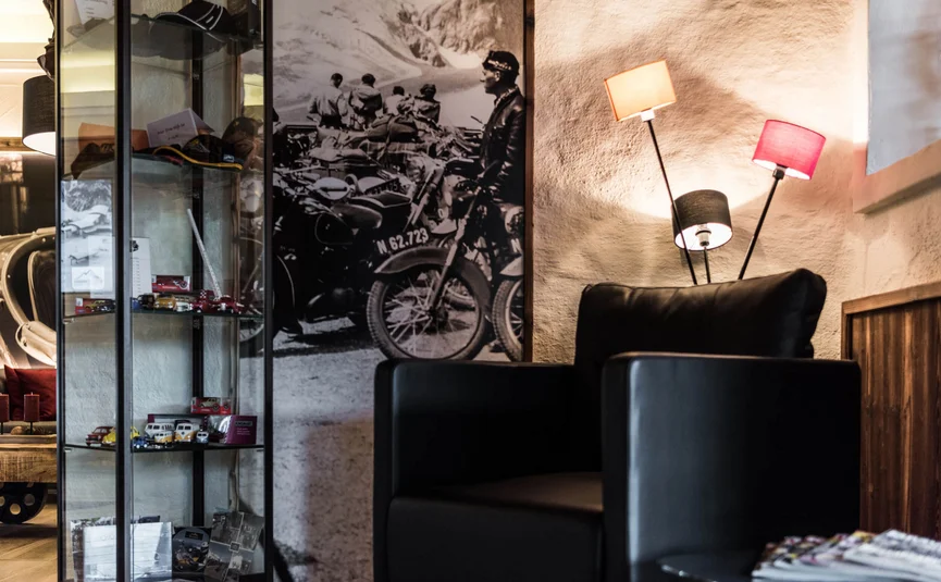 Cozy corner with black leather armchair and vintage motorcycle photo on the wall