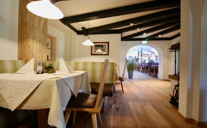 Cozy restaurant area with wooden furniture and set tables