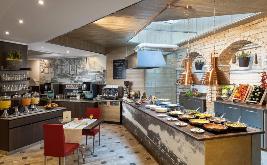 Modern breakfast buffet area with food and drinks