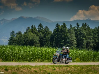 3 Peaks - Kronplatz - Eisack Valley © Moppetfoto.de Two motorcyclists riding on a road with forest and mountains background