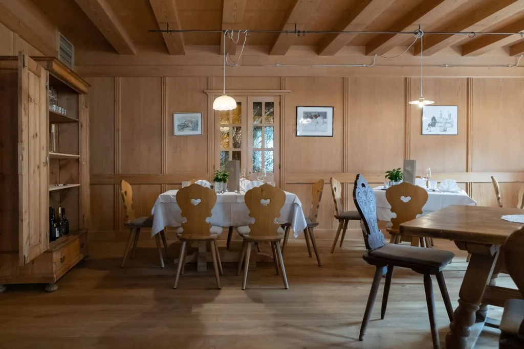 Traditional dining room with wooden furniture and table set with white tablecloth