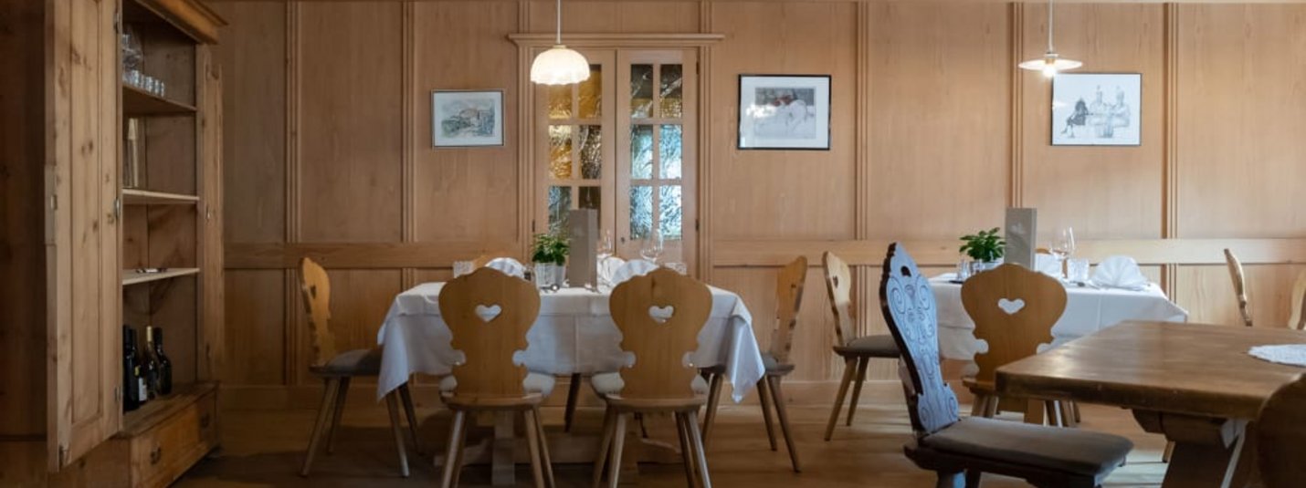 Traditional dining room with wooden furniture and table set with white tablecloth