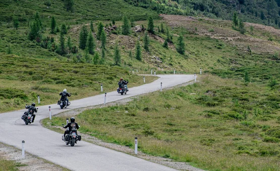 Motorbike holidays in East Tyrol - Grossglockner - Lienz Dolomites © Armin Kleinlercher Four motorcyclists riding on a winding road through green mountainous terrain