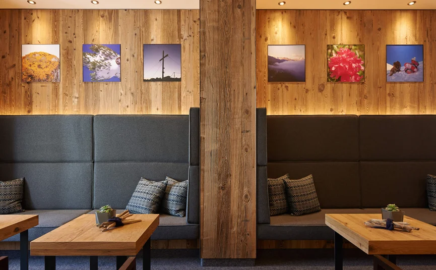 Cozy wooden wall with seating areas and landscape pictures