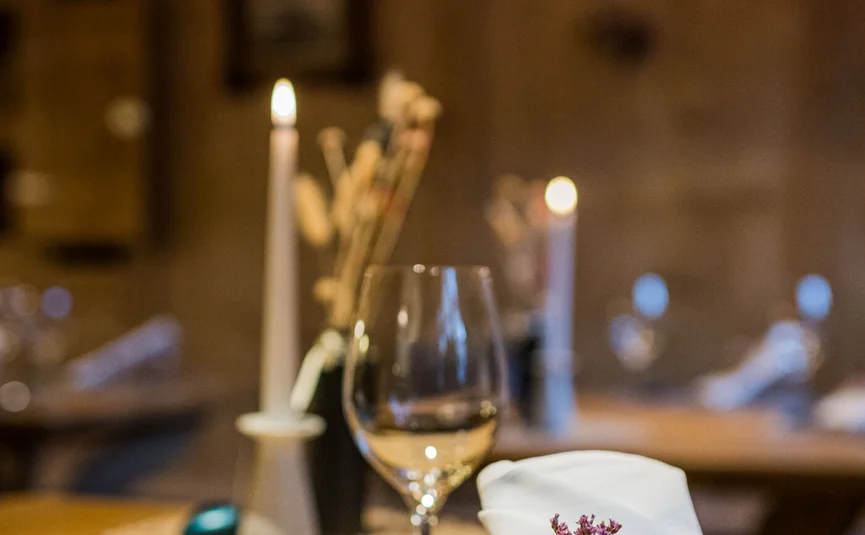 Festive table setting with wine glass and napkin decorated with dried flowers