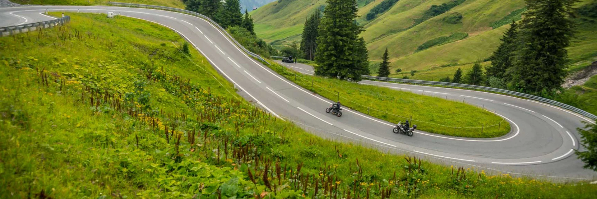 Schönauer Hof *** © Moppetfoto.de Winding mountain road with two motorcyclists and green hills