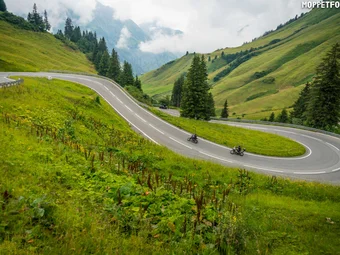 Lechtal - Hahntennjoch © Moppetfoto.de Winding mountain road with two motorcyclists and green hills