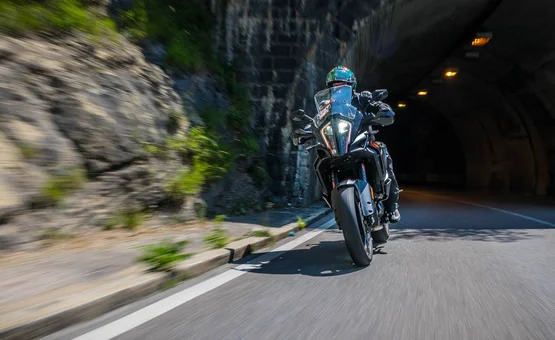 Motorbike holiday in Bavaria © Moppetfoto.de Motorcyclist riding through a tunnel beside a rocky wall