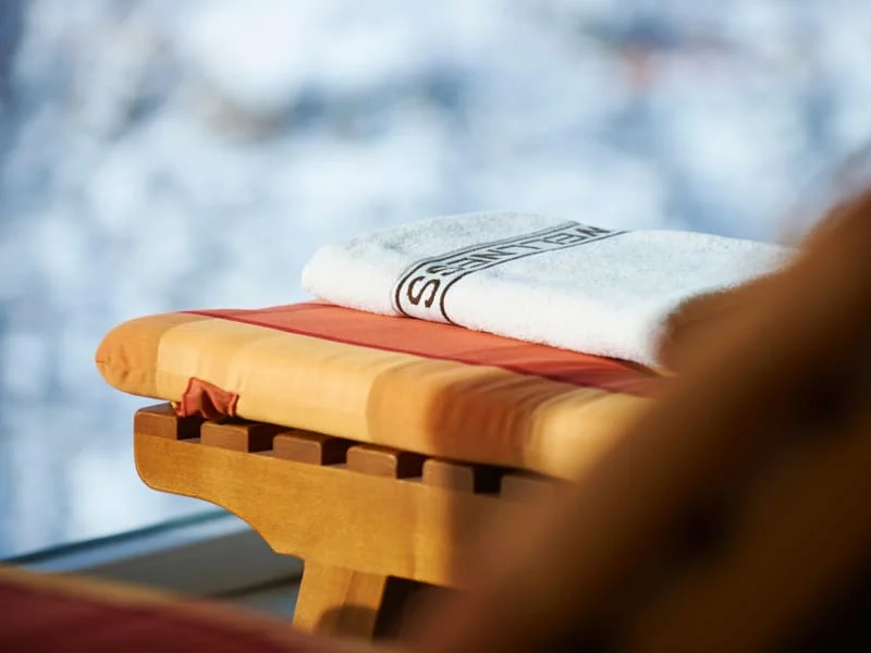 Towel on padded wooden chair with blurred background