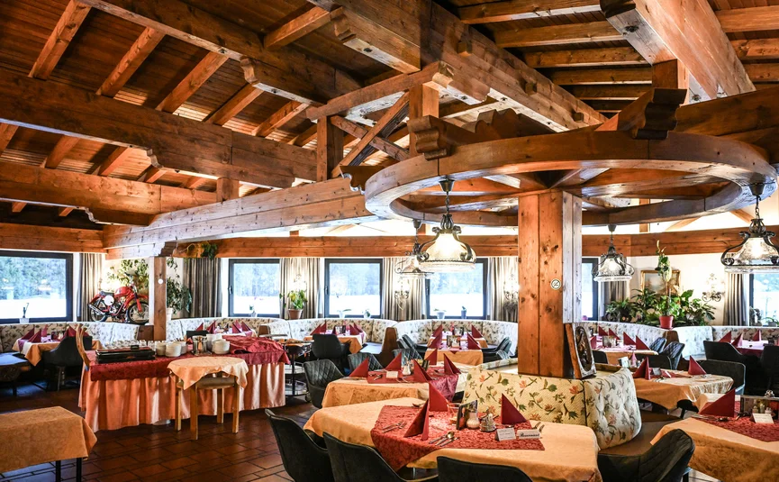 Rustic restaurant with wooden beams and festively set tables