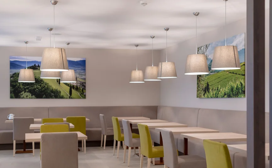 Modern dining area with tables, chairs, and pendant lights
