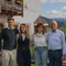 Family photo in front of a house with mountains in the background