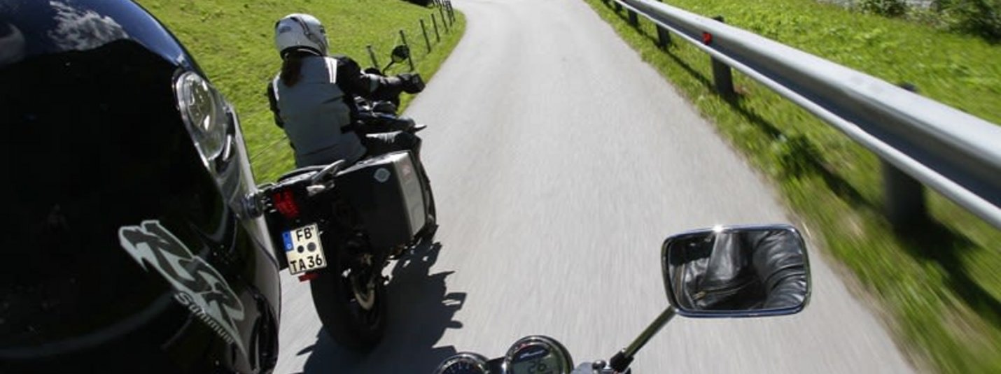 Super Tourenwoche Zwei Motorradfahrer auf einer kurvenreichen Landstraße in den Bergen