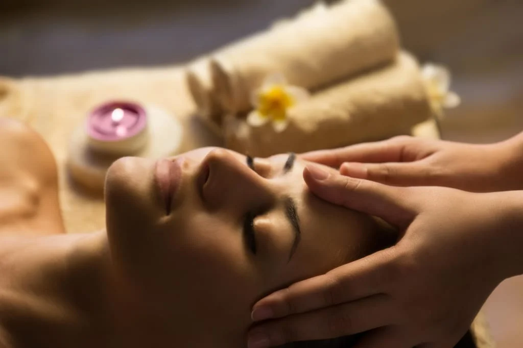 Frau erhält entspannende Gesichtsmassage im Spa