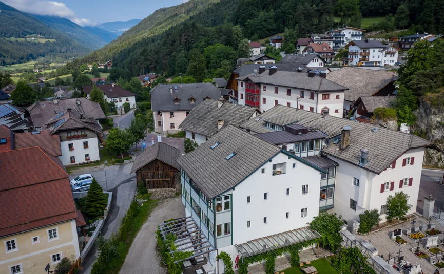 Village with traditional houses in a green mountain valley