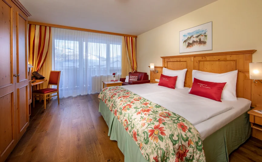Cozy hotel room with double bed and balcony window