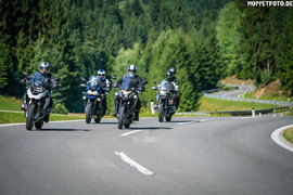 Henpstpass Tour 368km Four motorcyclists riding on a country road with forest background
