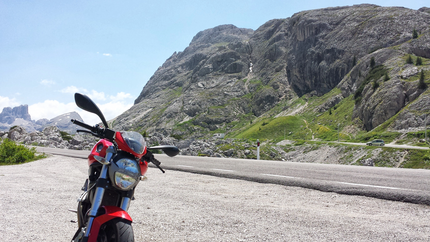 Kleine Hausrunde - Moar's Hotel Rotes Motorrad auf Bergstraße mit Felsen und grünen Hängen im Hintergrund