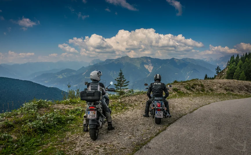 Gailtaler Hof © Moppetfoto.de Two motorcyclists stopped on a mountain road overlooking the Alps