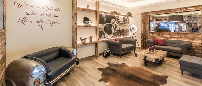 Cozy waiting area with car-themed sofa and wooden decor